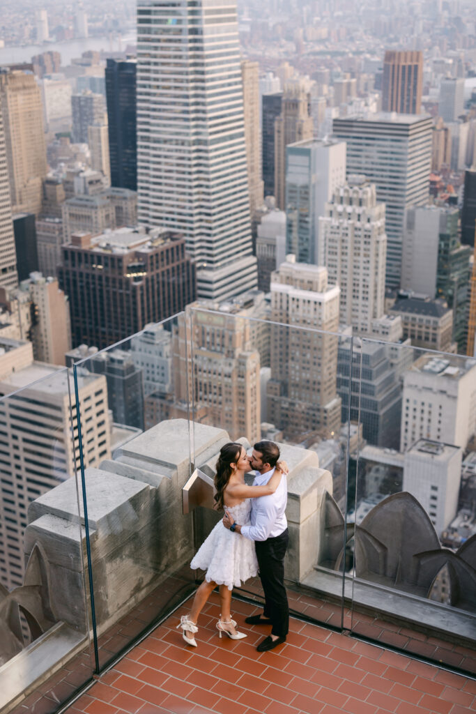 Olya and Felipe sharing an intimate moment at sunset during their couple’s shoot at Top of the Rock, Rockefeller Center.